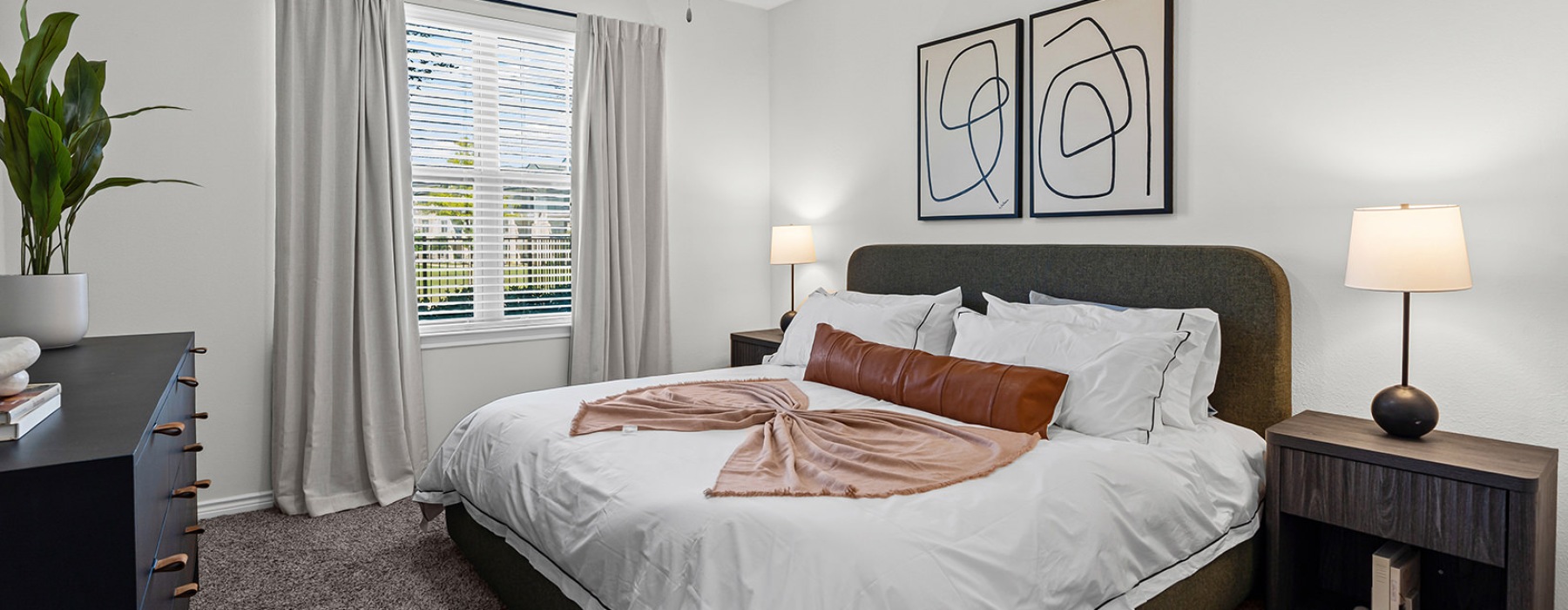 Cozy bedroom with a large window at 4 Corners apartments in Frisco, TX.